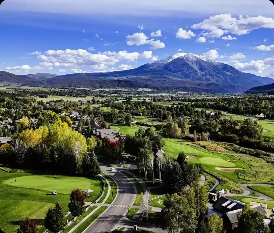 Aerial view of the Roaring Fork Valley with a golf course and Mount Sopris