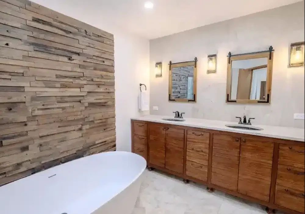Double vanity with walnut cabinetry and bronze fixtures