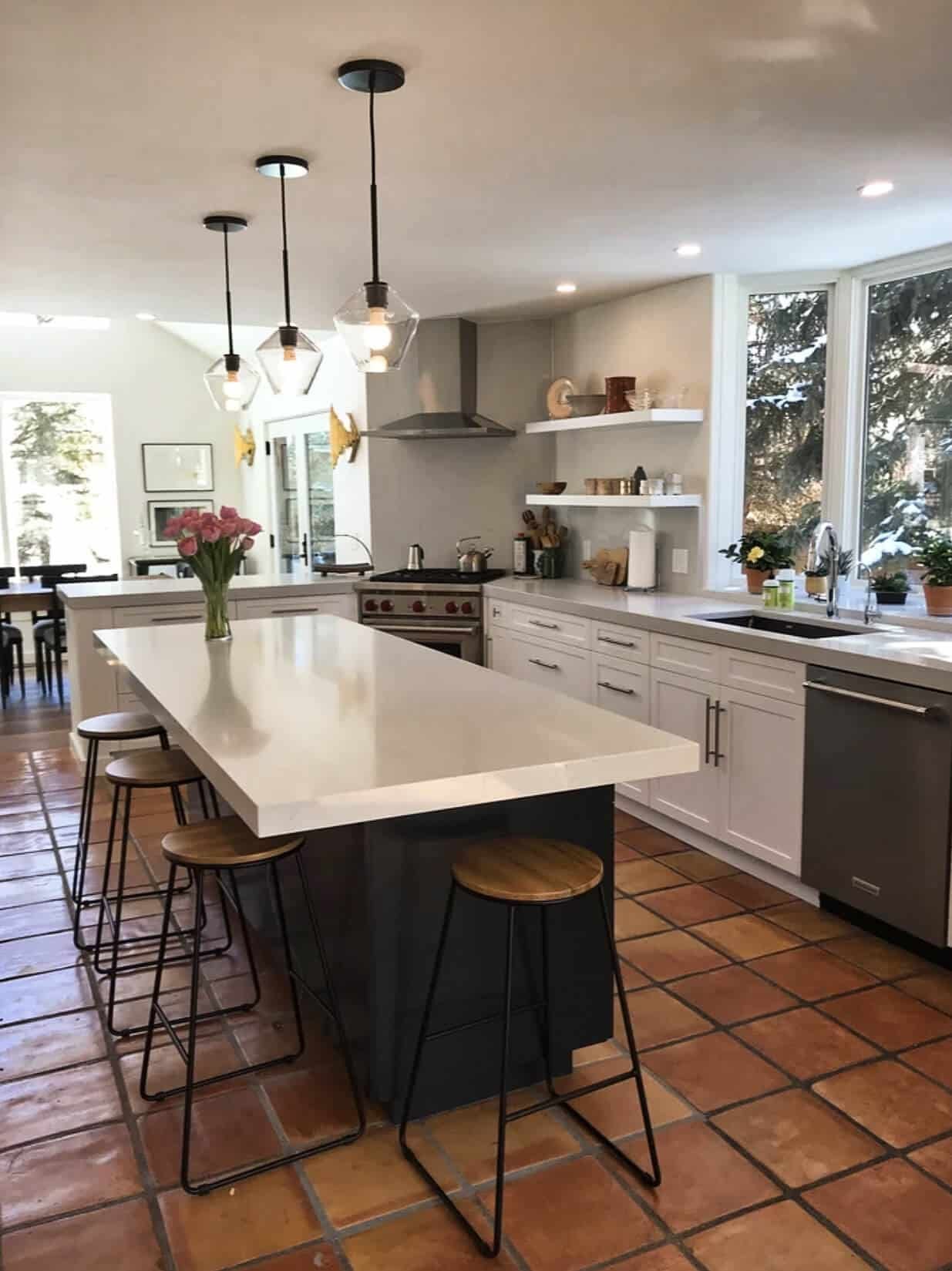 Remodeled Basalt kitchen with a white quartz island, bar stools and terracotta tile floor