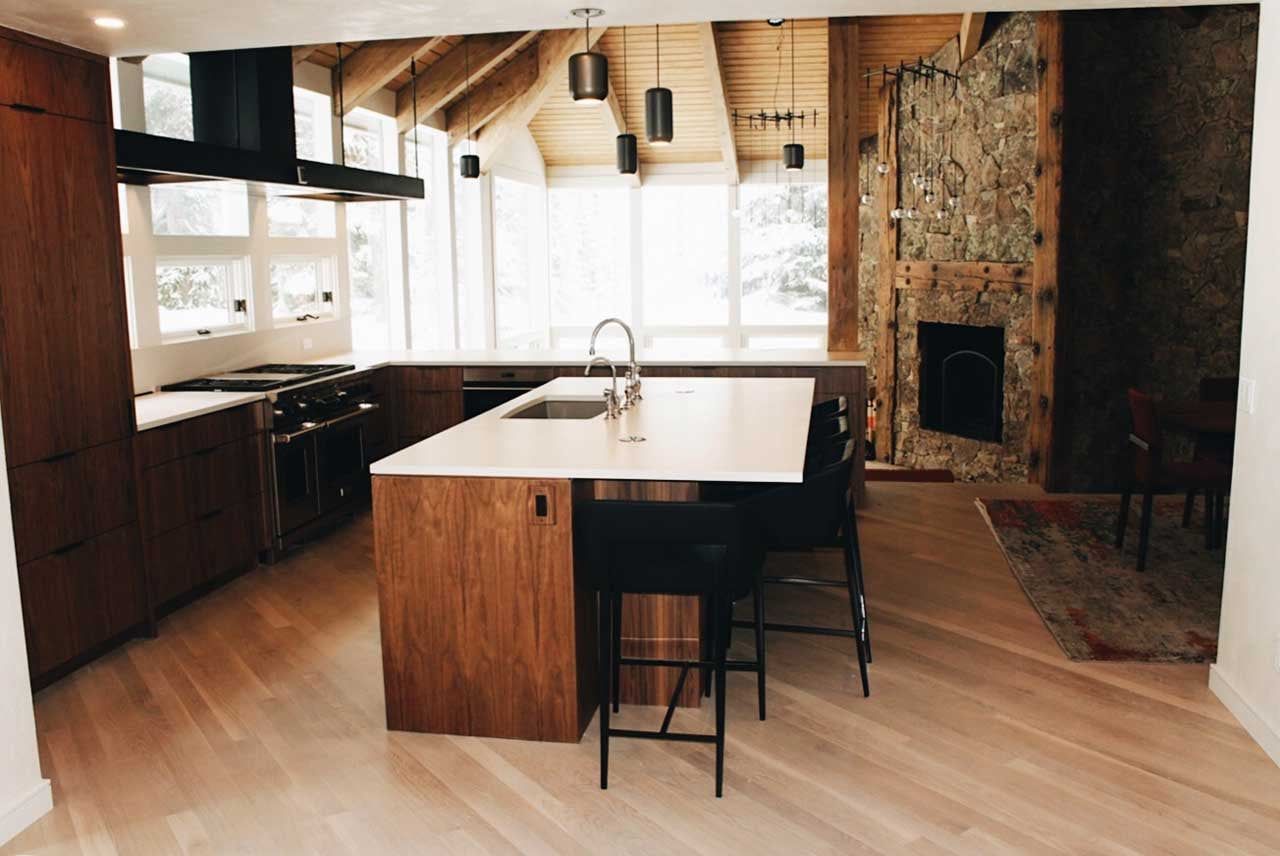 Starwood Mountain Retreat kitchen remodel with a walnut island, stone fireplace and vaulted wood ceiling