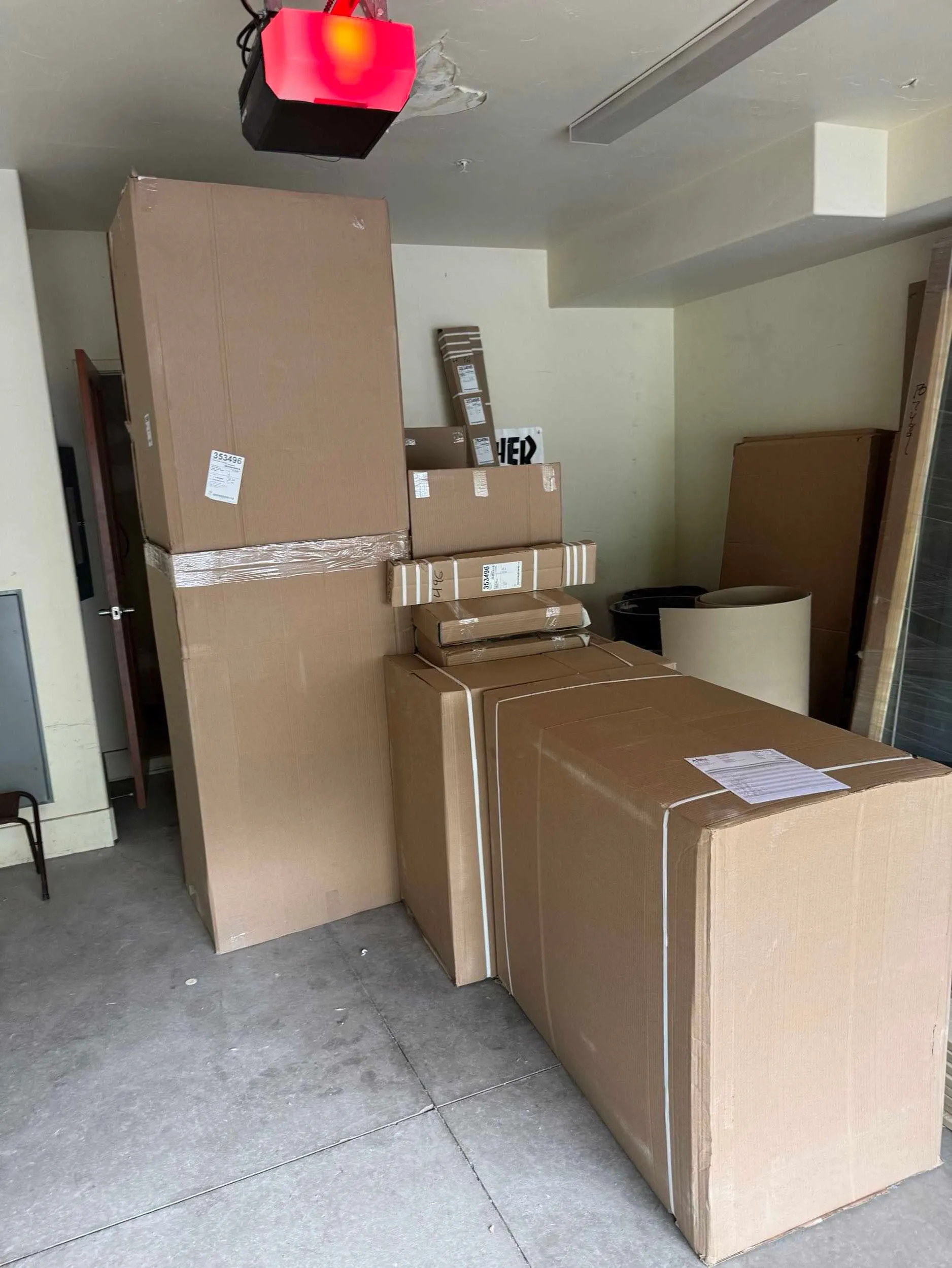 Boxed vanity cabinets delivered and staged inside a condo during a remodel
