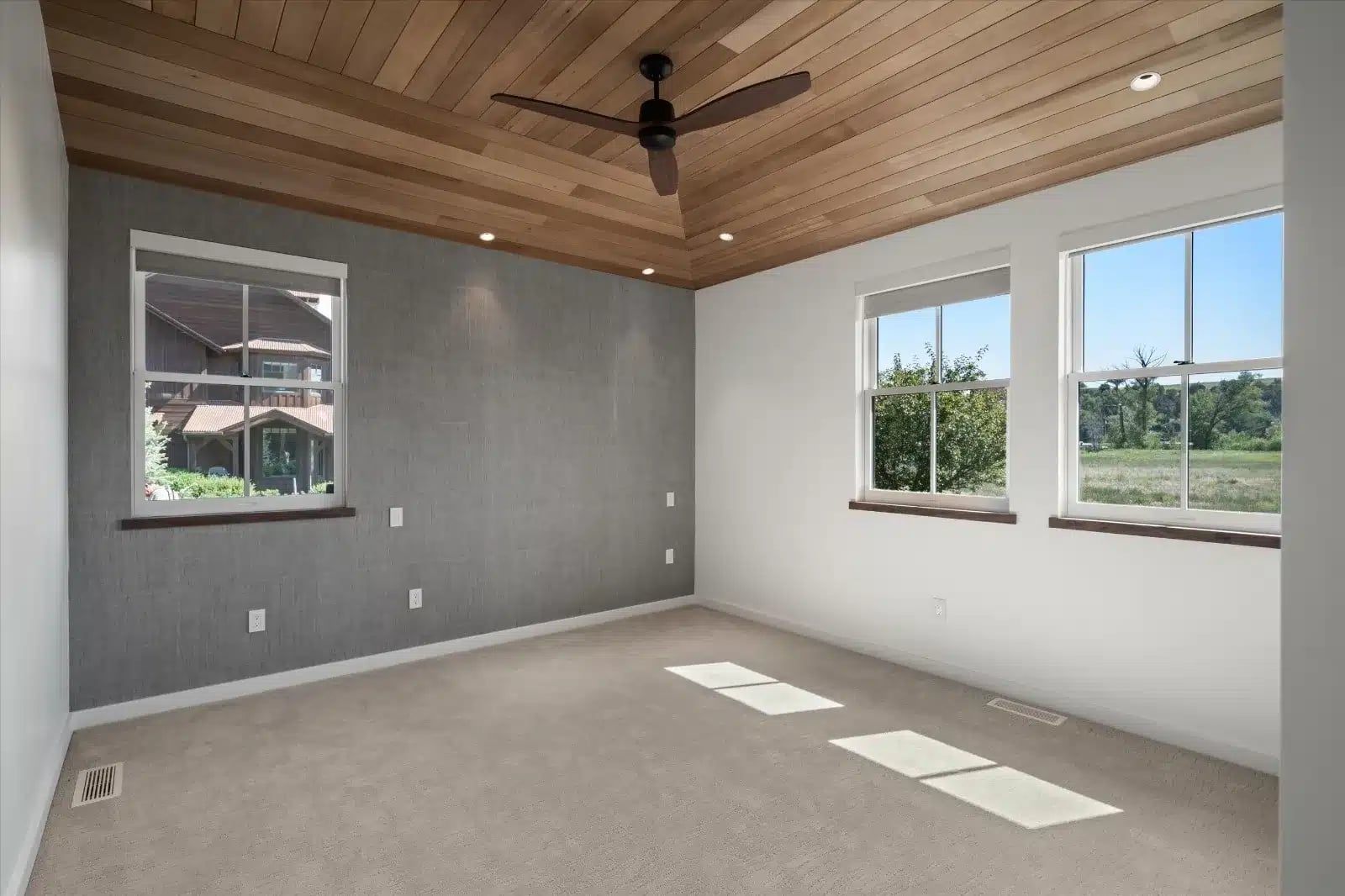 Finished bedroom at 114 Crystal Canyon with a wood plank ceiling, ceiling fan and gray accent wall