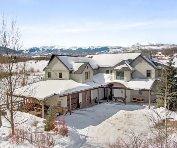 Custom home in the snow with mountain views