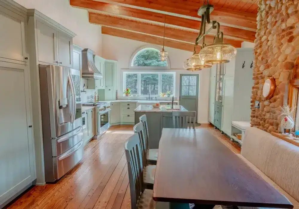 Remodeled kitchen and dining area with a stone accent wall