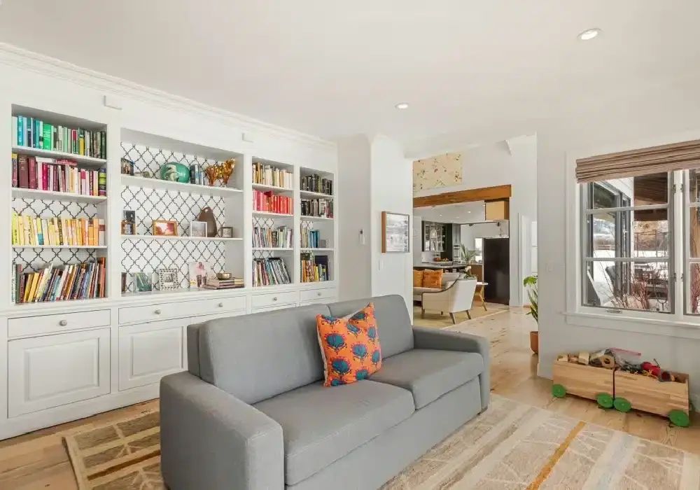 Living room with a wall of built-in bookshelves