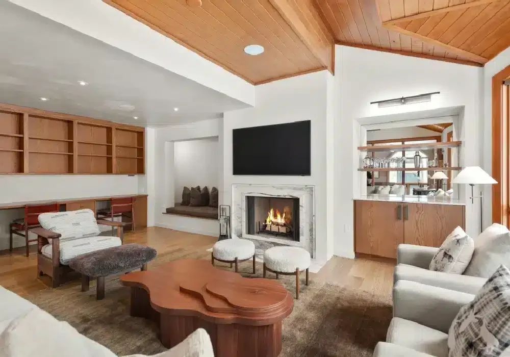 Living room with wood ceiling, fireplace and built-in shelves