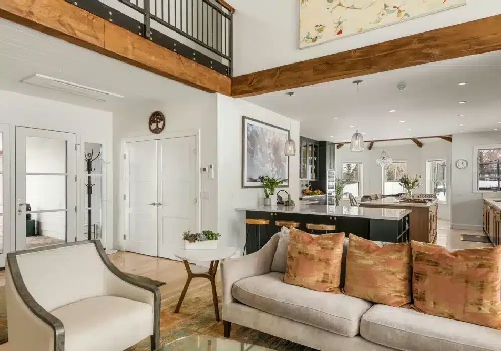 Open living room with loft railing and kitchen beyond