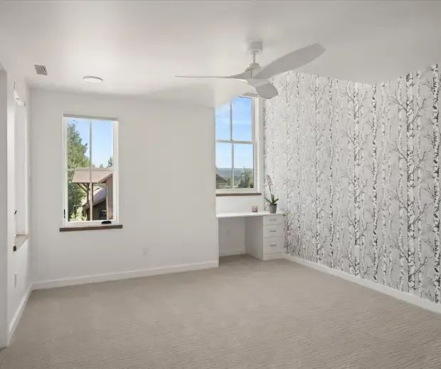 Bedroom with birch-tree wallpaper accent wall and built-in desk