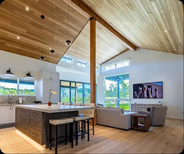 Great room with vaulted cedar ceiling, kitchen island and seating area