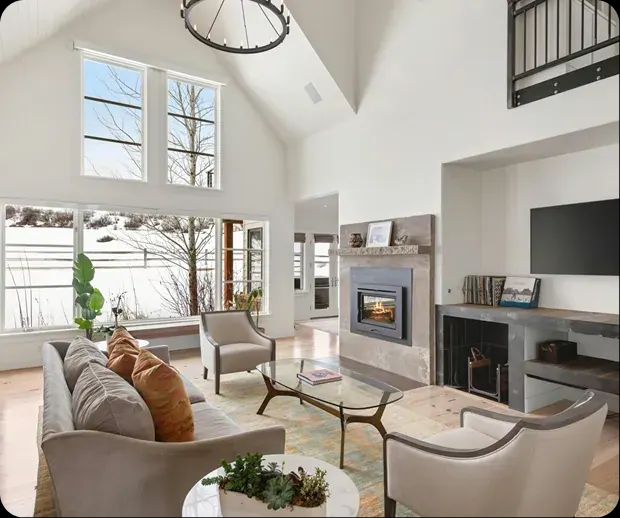Vaulted living room with tall windows and a gas fireplace