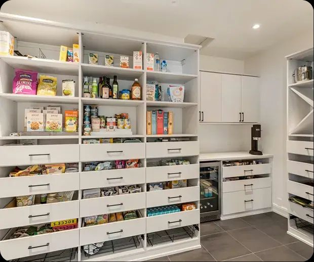 Walk-in pantry with custom open shelving and pull-out drawers