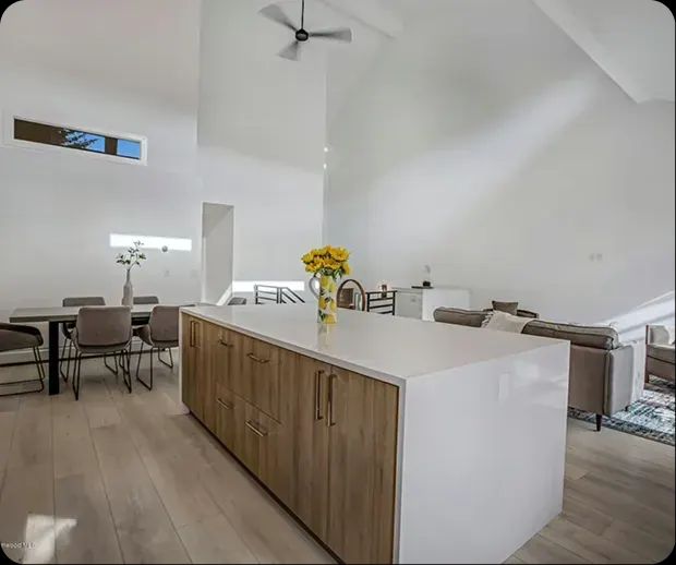 Wood kitchen island in an open plan with dining area