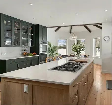 Remodeled kitchen with wood island and gas cooktop