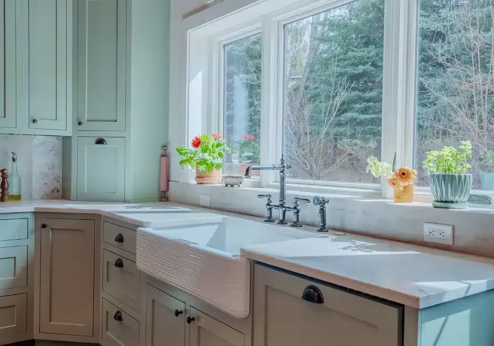 Sage green kitchen with copper range hood