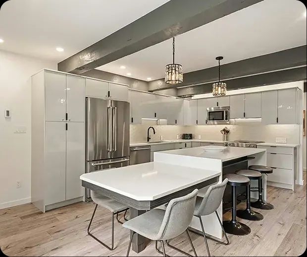 Kitchen island with dining chairs under a timber beam
