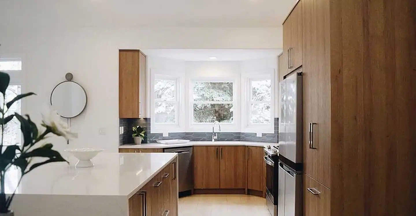 Kitchen with wood cabinets and a sink below a bay window