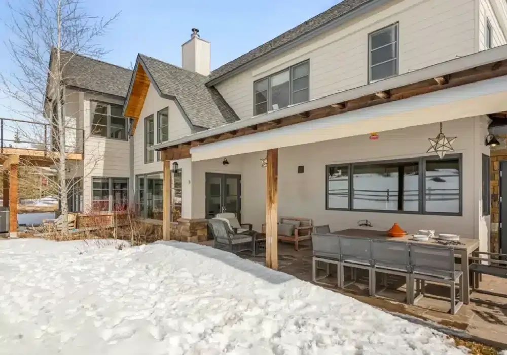 Covered patio on a new custom home after snowfall