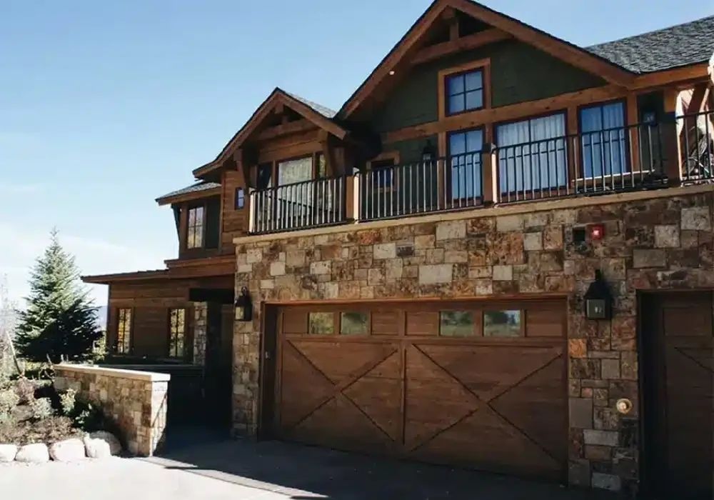 Custom home with stone garage and timber balcony
