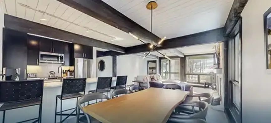 Remodeled Aspen kitchen and dining room with dark cabinets and live-edge table