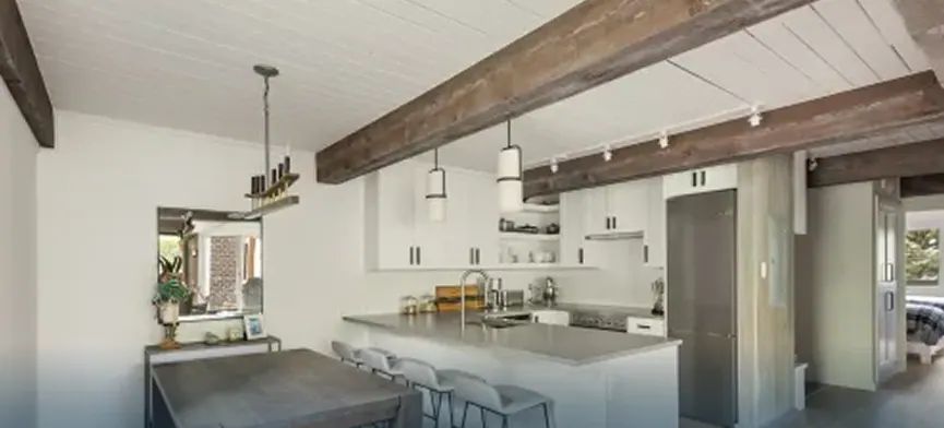 Remodeled Aspen kitchen with reclaimed beams and peninsula seating